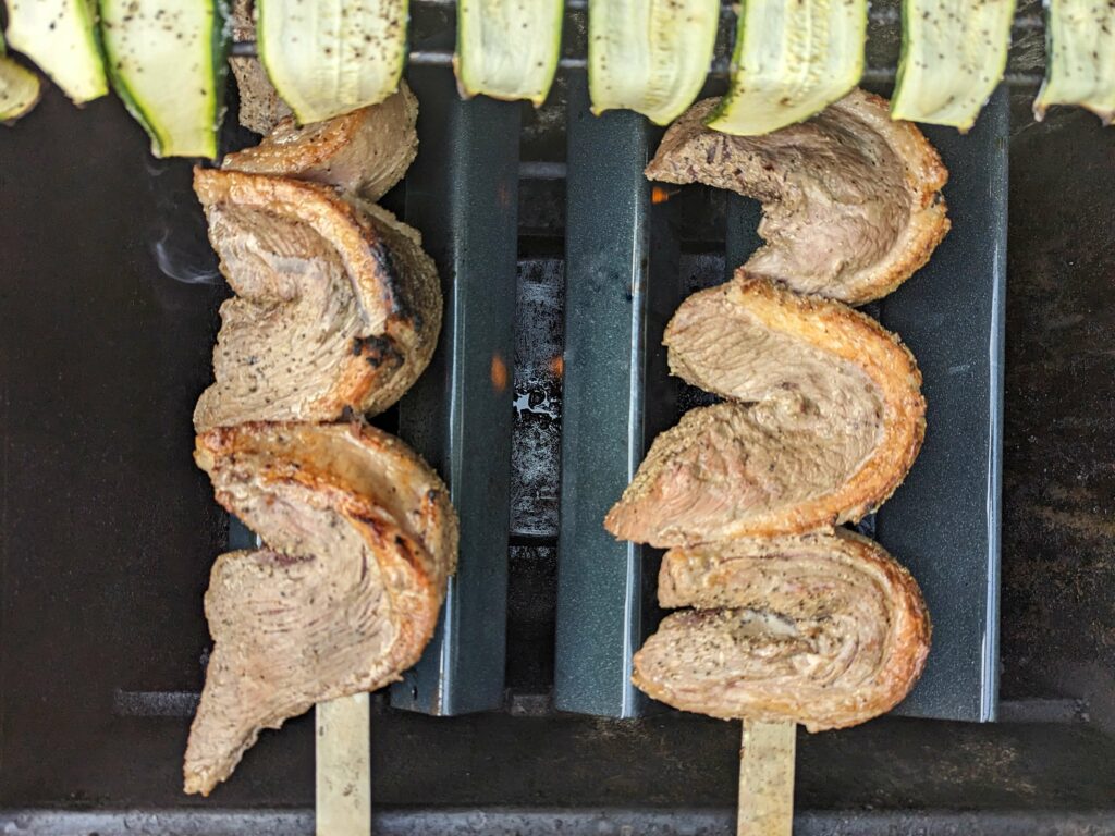 Grilled picanha cooking on the grill.