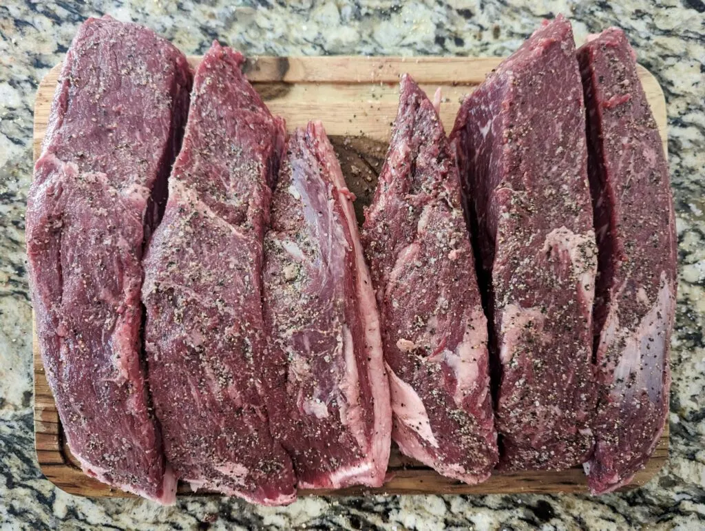 The triangular brazilian steak cut into three to four long pieces.