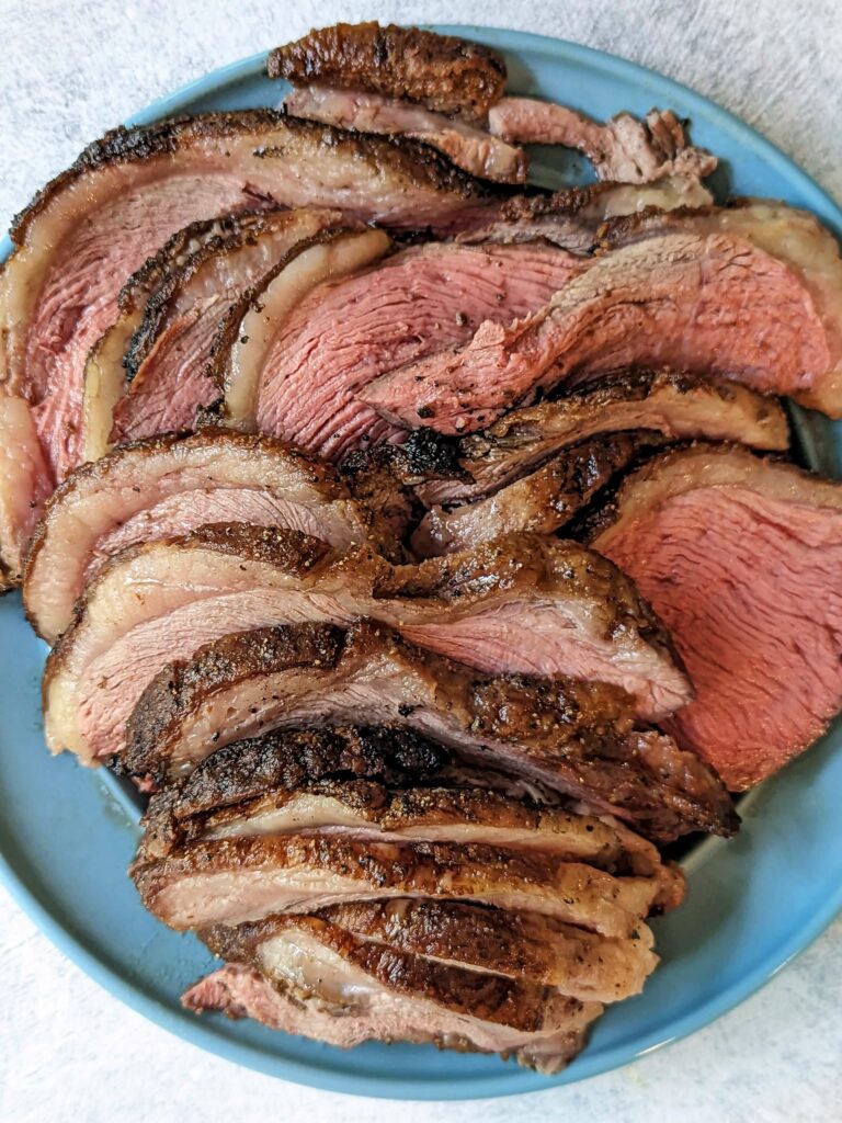 Sliced Grilled Picanha on a serving plate.