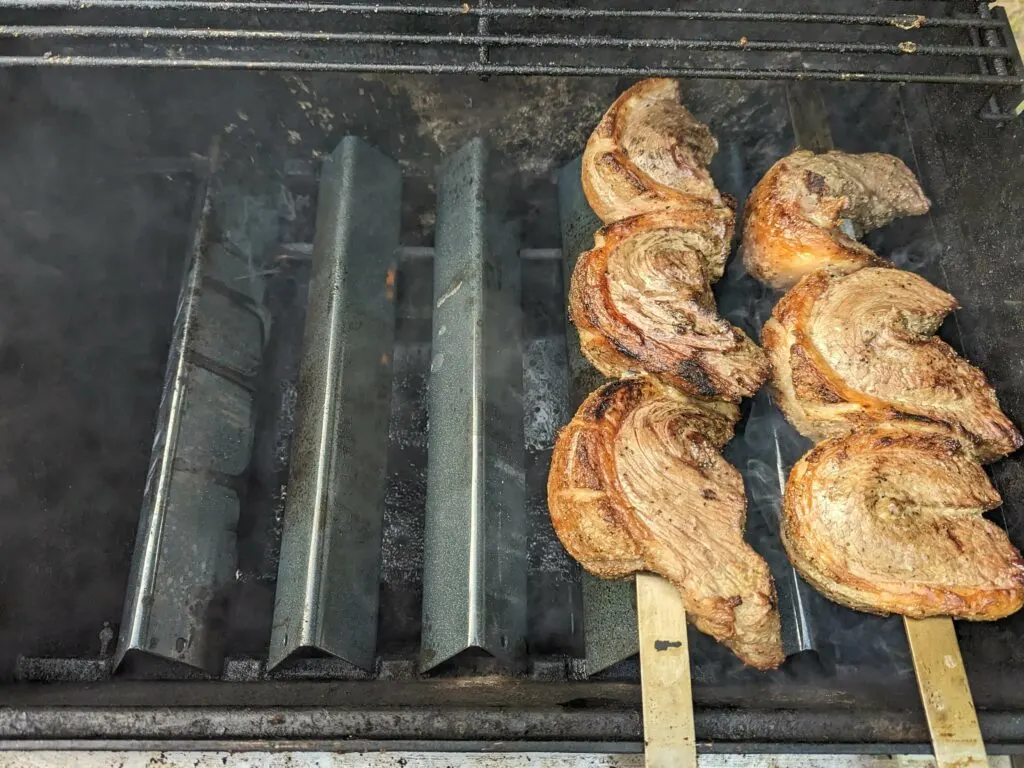 Grilled picanha cooking on the grill using indirect heat.