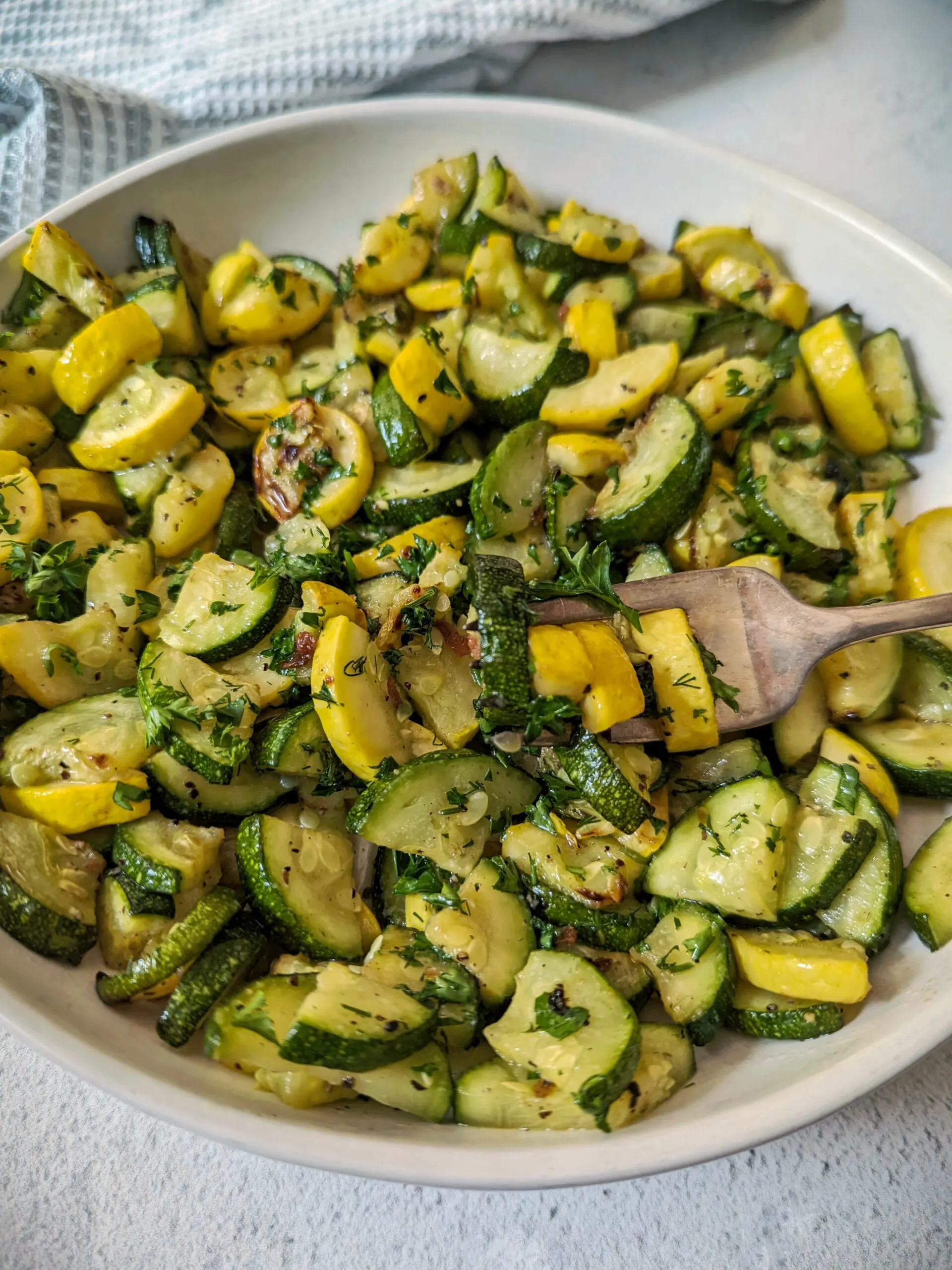 Air fryer zucchini and squash in a serving bowl.