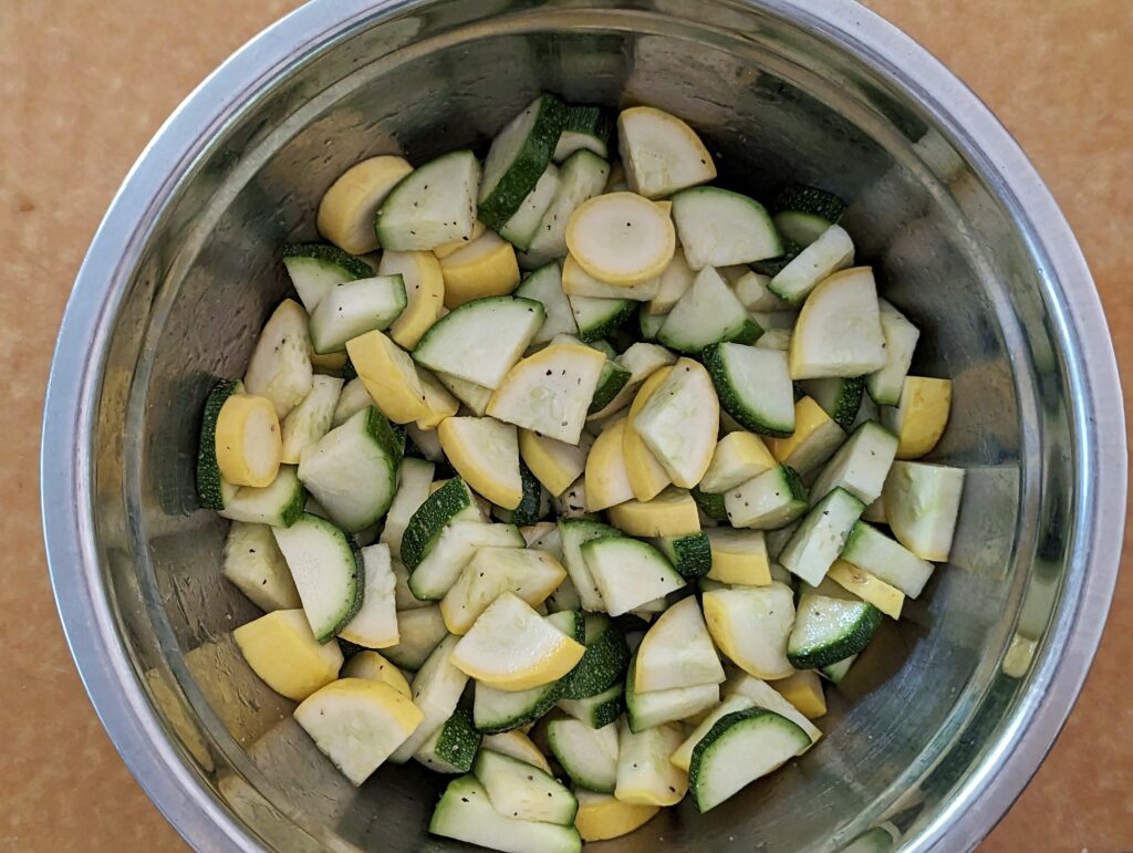 Zucchini and squash in a mixing bowl.