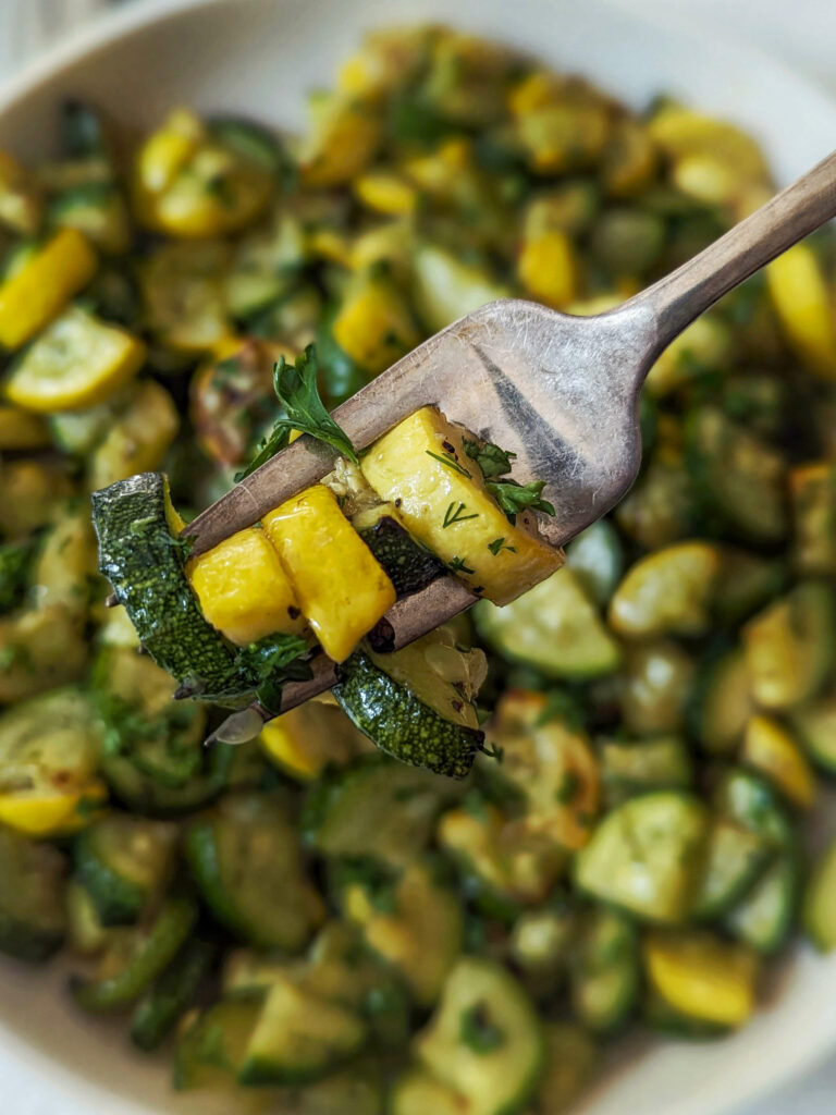 A scoop of zucchini and squash on a fork.