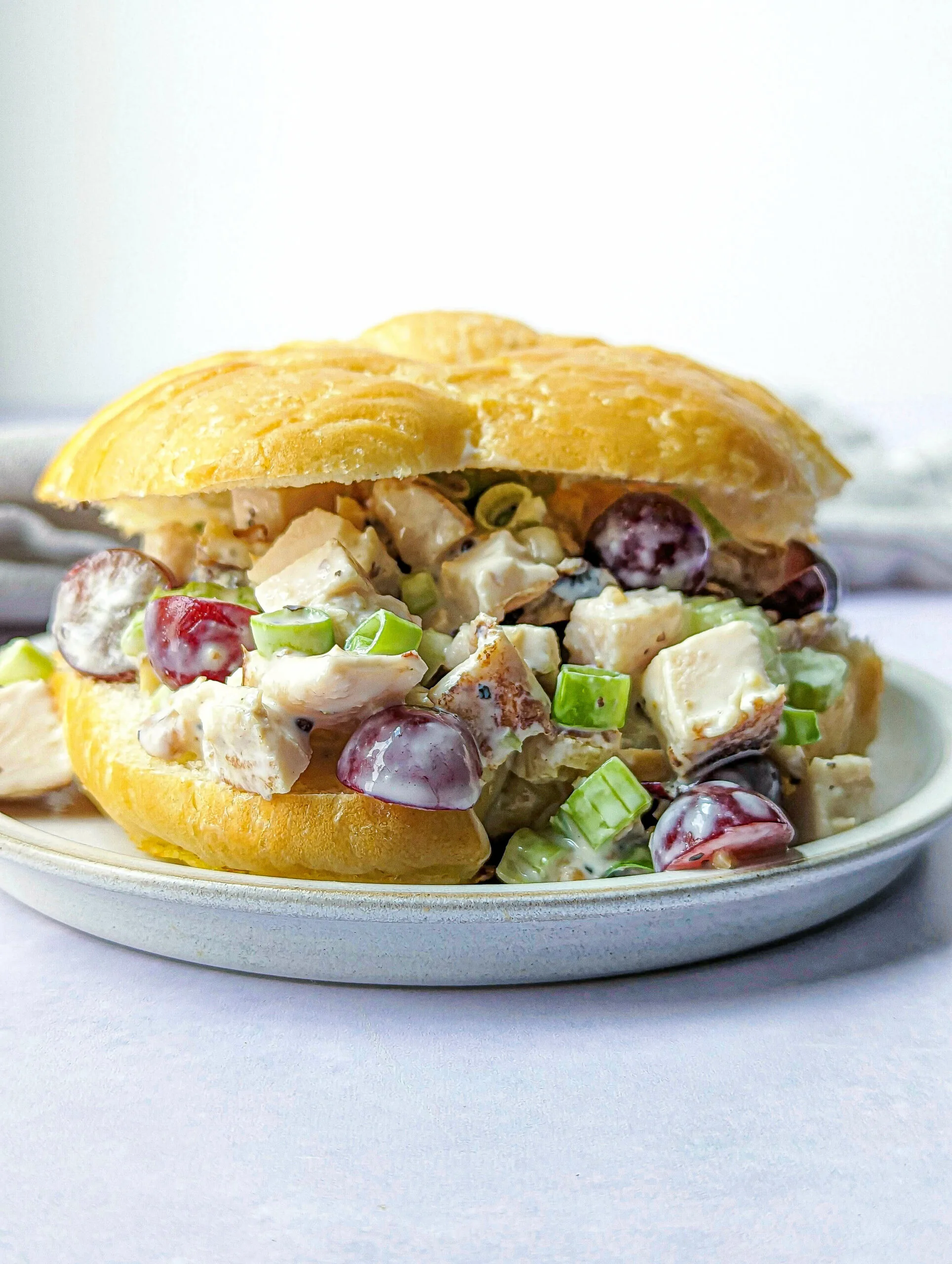 A croissant filled with california chicken salad.