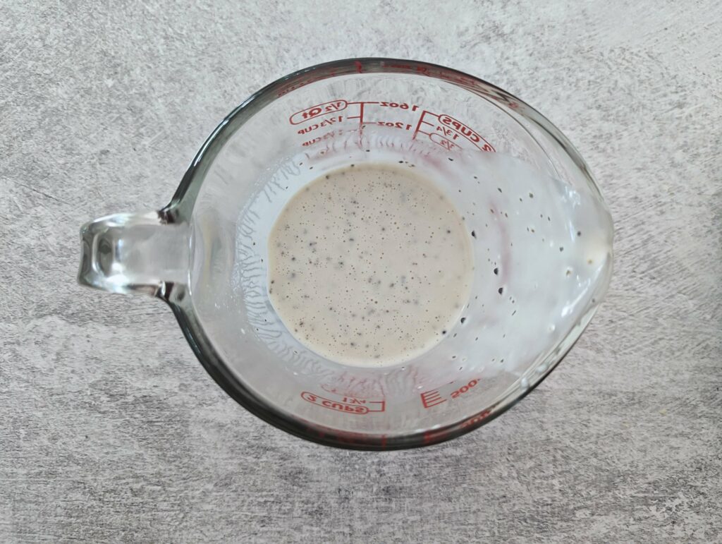 The ingredients for the dressing combined in a liquid measuring cup. 
