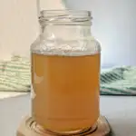 A glass jar of cardamom simple syrup.