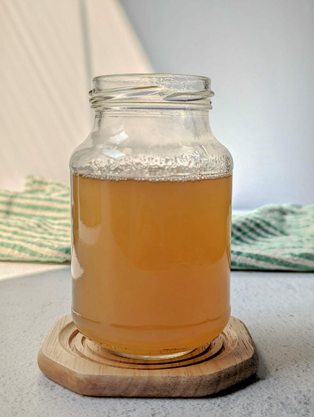 A glass jar of cardamom simple syrup.