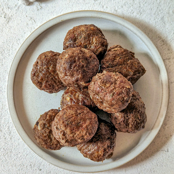 A plate showing what meatballs look like to answer the questions How Long to Bake Meatballs at 350.