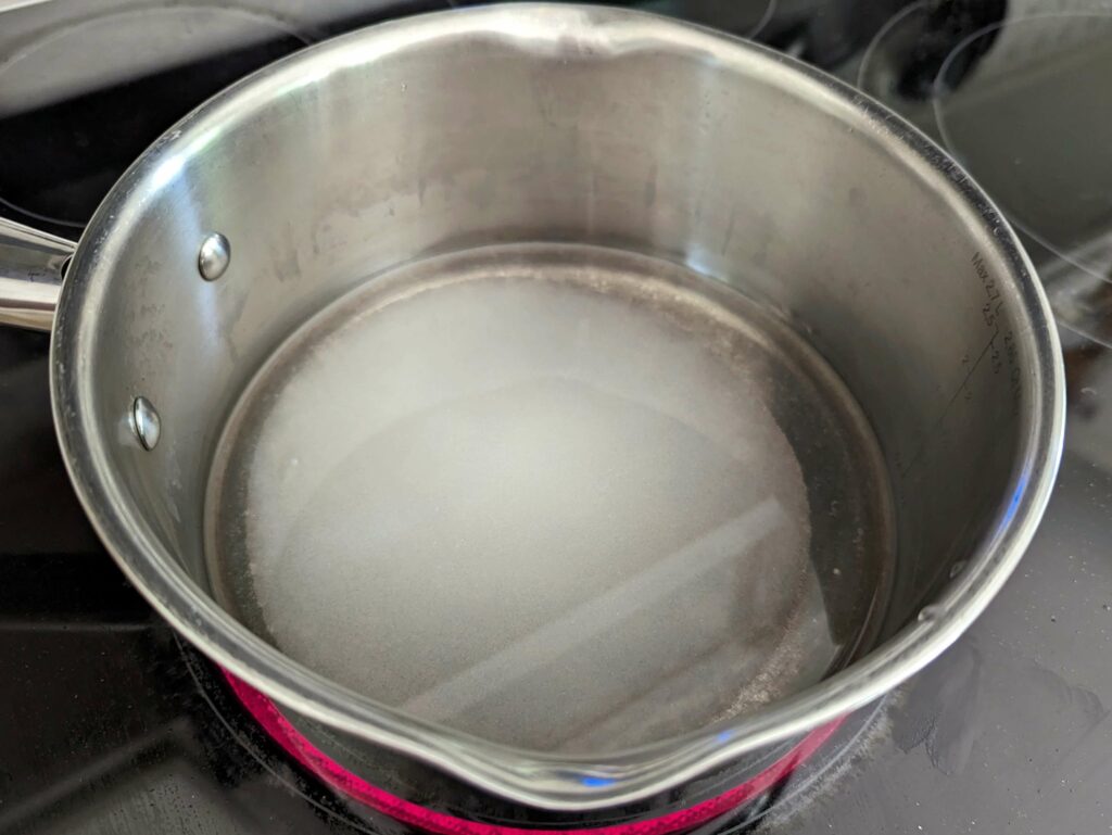 Water and sugar in a saucepan.