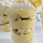 A side view of three cups of banana pudding cups showing the layers.