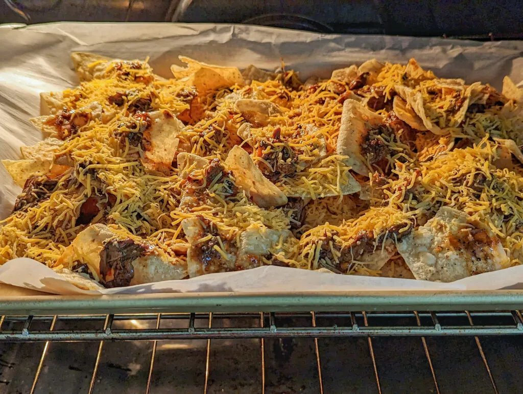 Birria nachos baking in the oven.