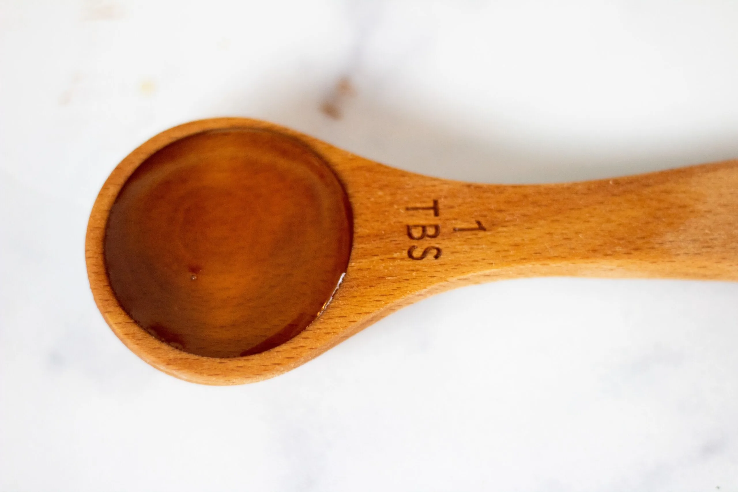 Maple syrup in a tablespoon.