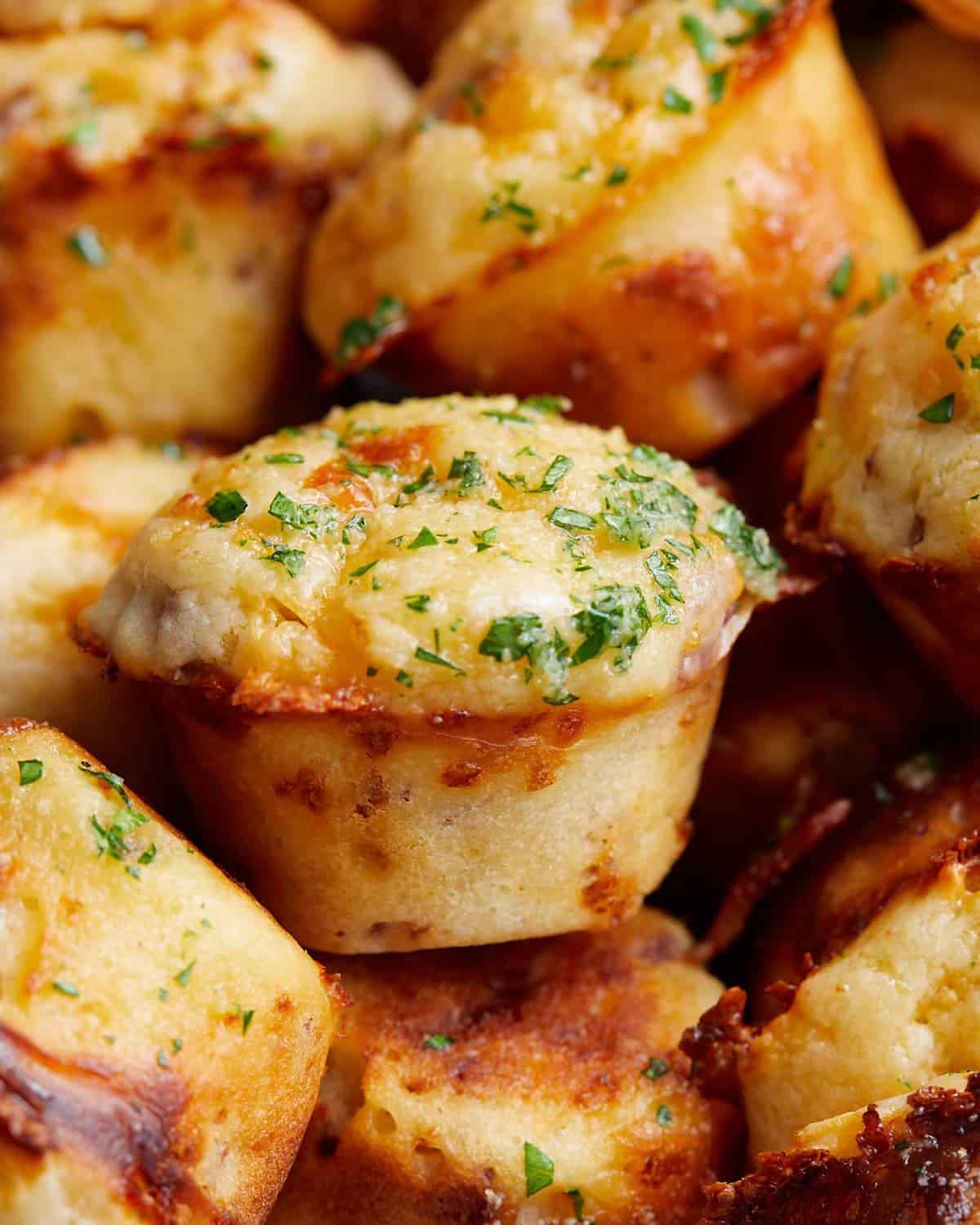 A close up of bacon cheddar muffins in a bowl.