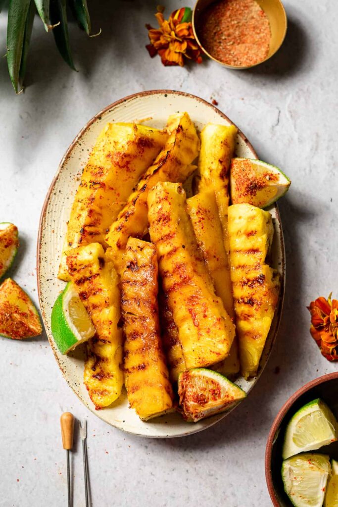 Grilled pineapple skewers on a serving plate.