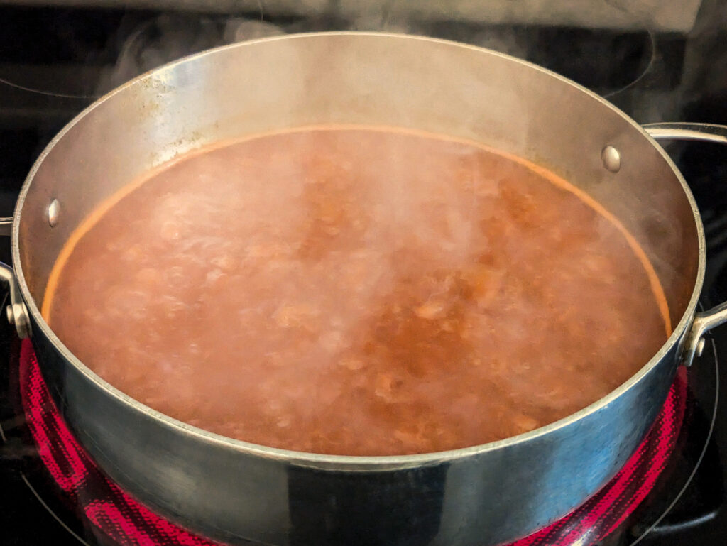 Spices and sugar added to the broth in the sauce pan.