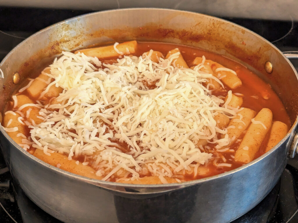 Cheese added to the top of the tteokbokki.
