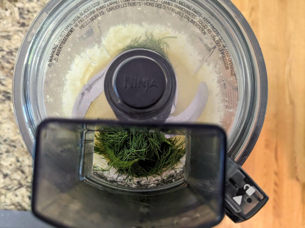 Dill added to the food processor with salt and pepper.
