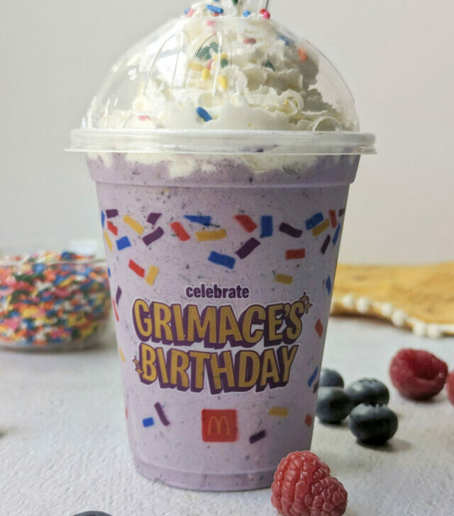 Grimace McDonalds Milkshake Recipe in a cup, topped with whipped cream and sprinkles.