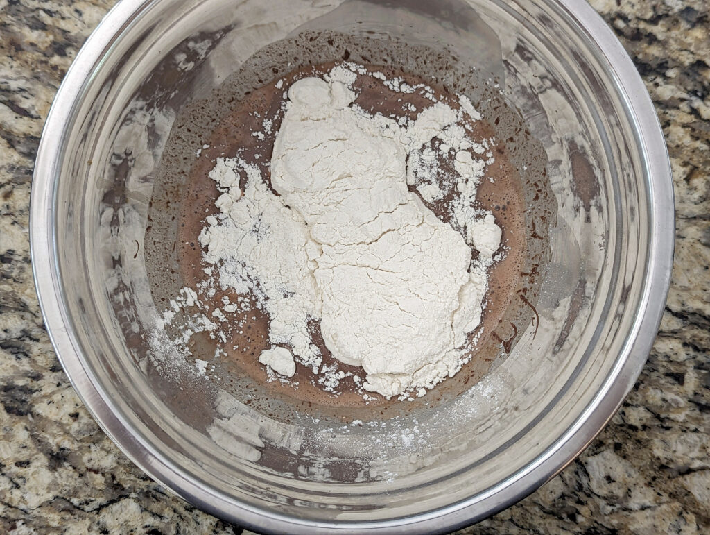 Flour added to the wet ingredients for the batter.