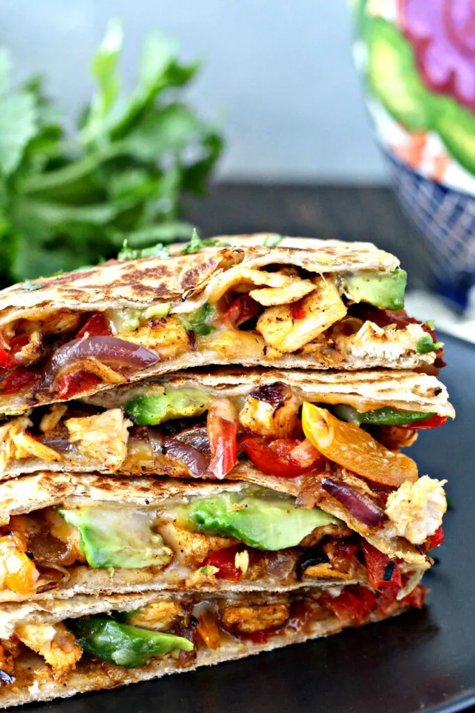 Chicken quesadillas stacked on a plate.