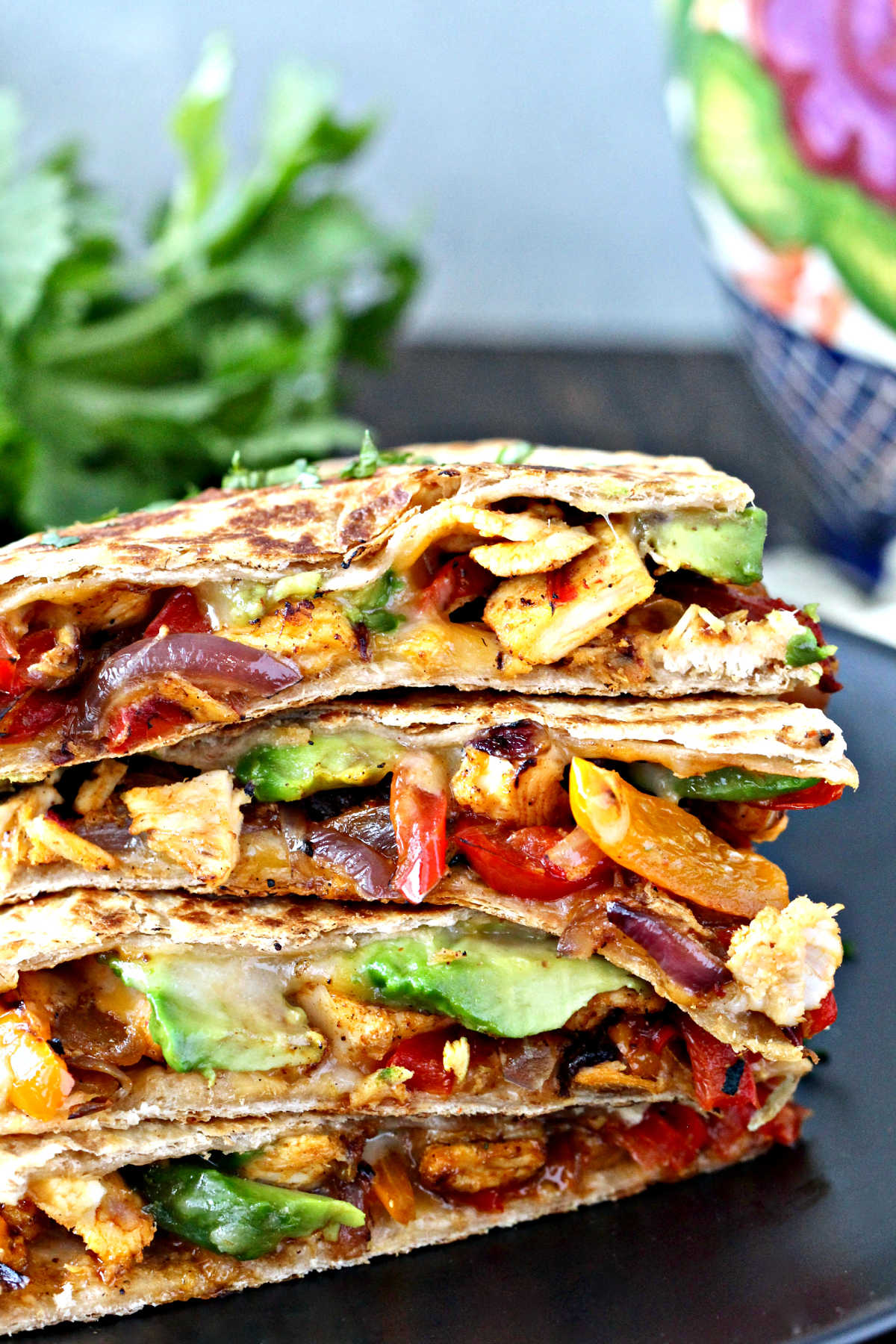 Chicken quesadillas stacked on top of each other so you can see all of the ingredients.
