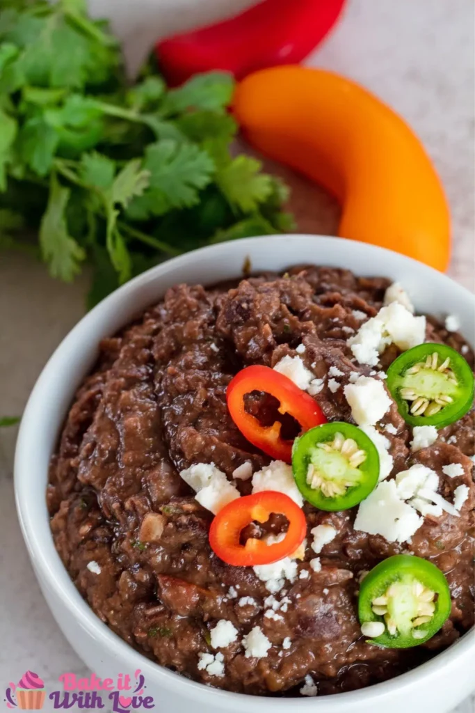 A bowl of refried black beans.