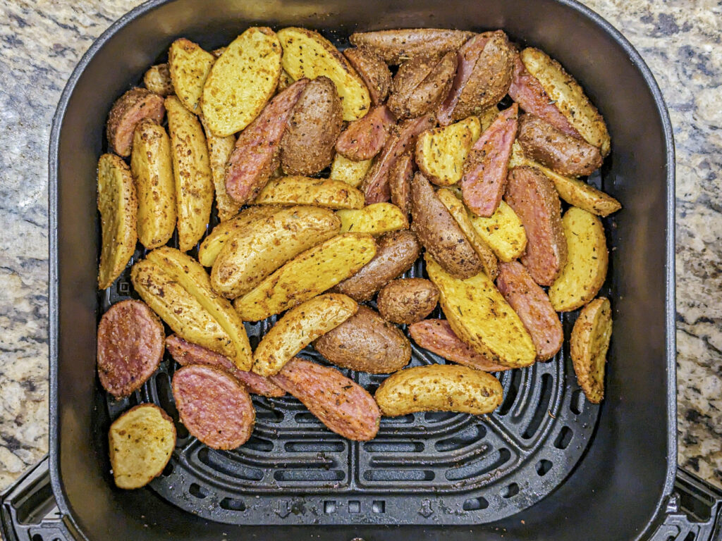 Fingerling Potatoes in an air fryer basket.