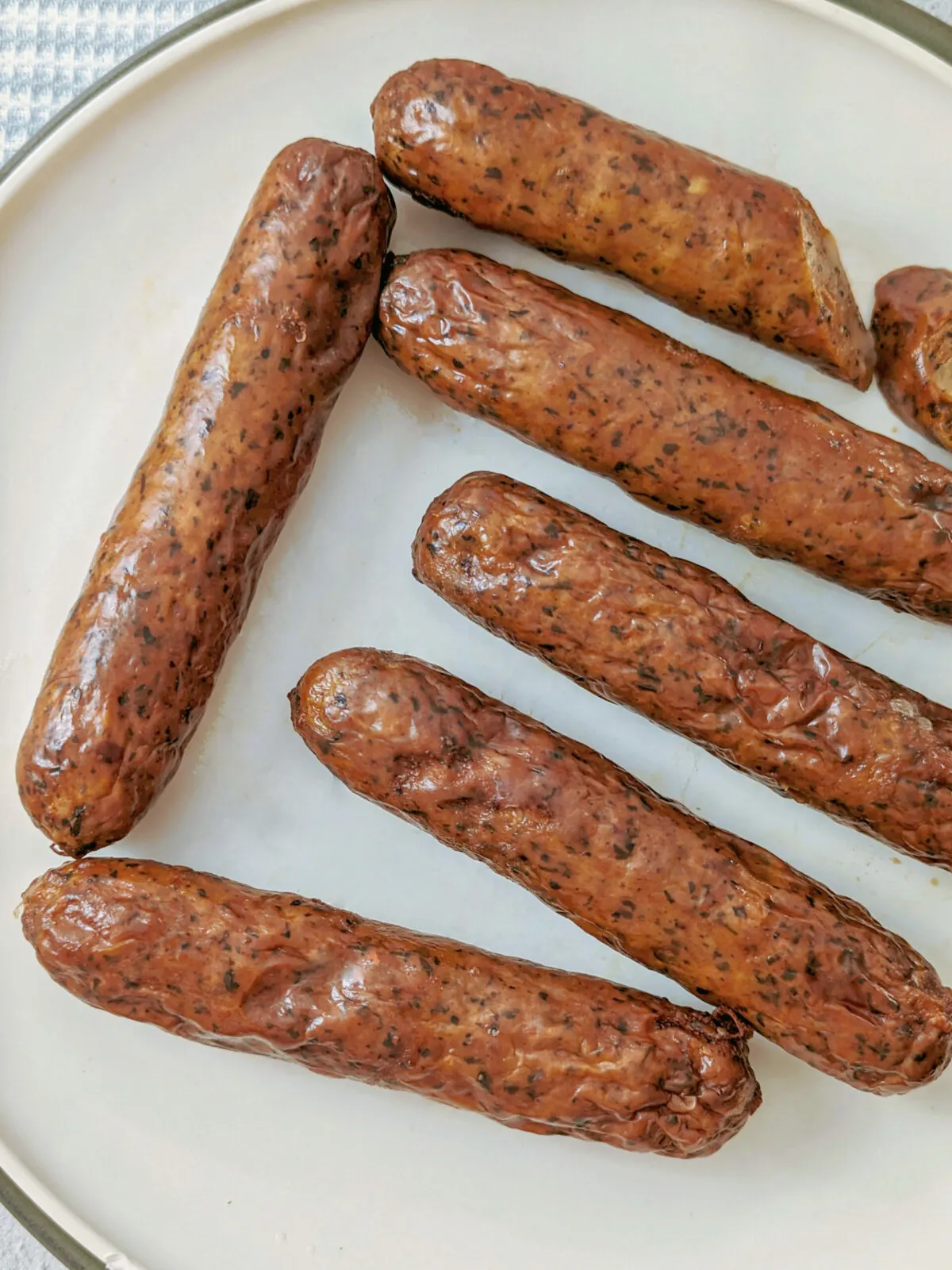 Chicken sausage links on a plate.