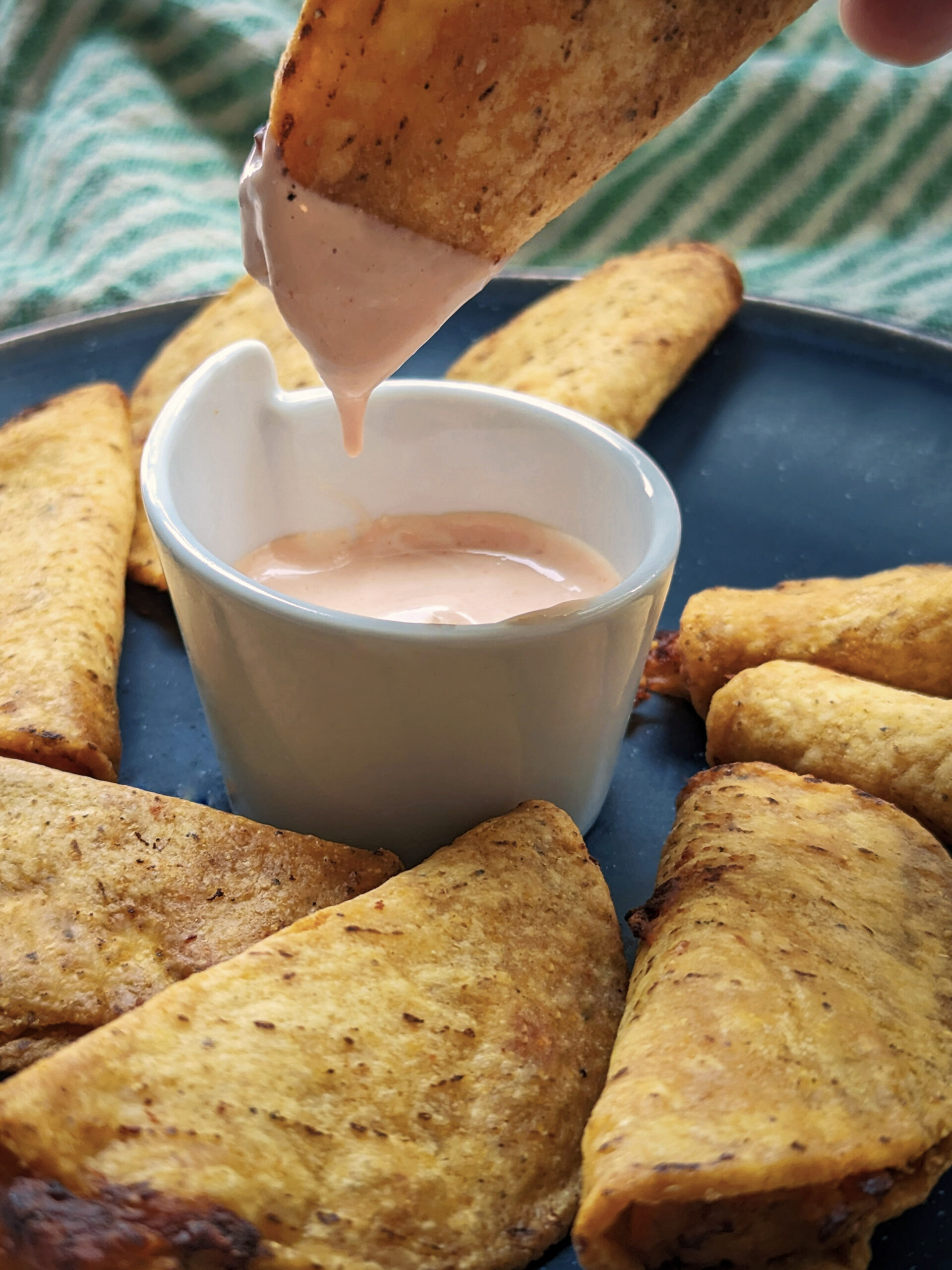 Air Fryer Mini Tacos on a plate with a sour cream and salsa dipping sauce.