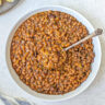 Baked beans with hamburger in a serving bowl.