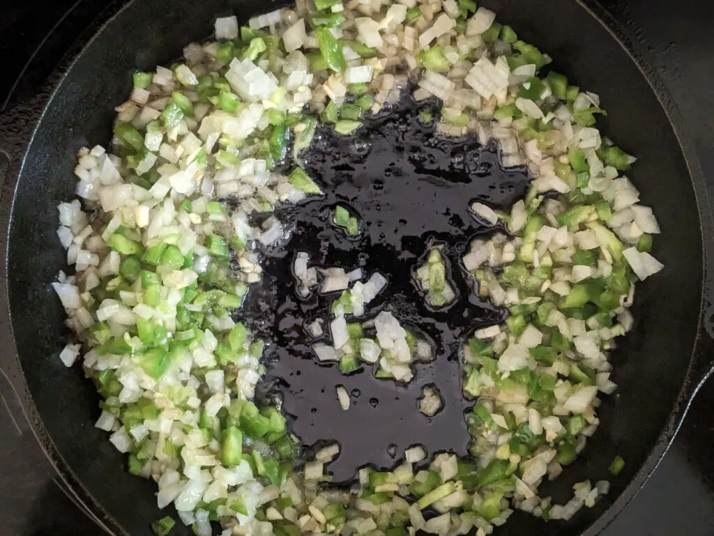 Vegetables searing in leftover bacon grease in the skillet.