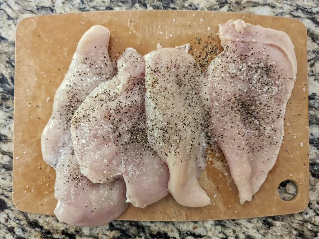 Chicken breasts cut into cutlets and seasoned with salt and pepper.