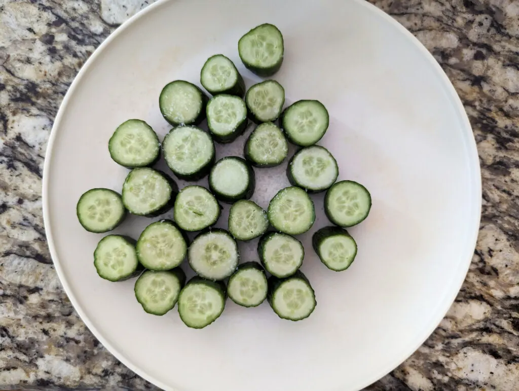 Salted cucumbers on a plate.