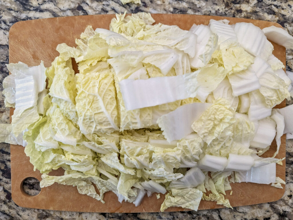 Cabbage cut into bite-sized pieces on a cutting board.