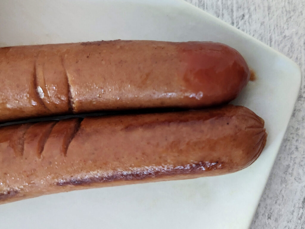 Hotdogs dipped in ketchup.