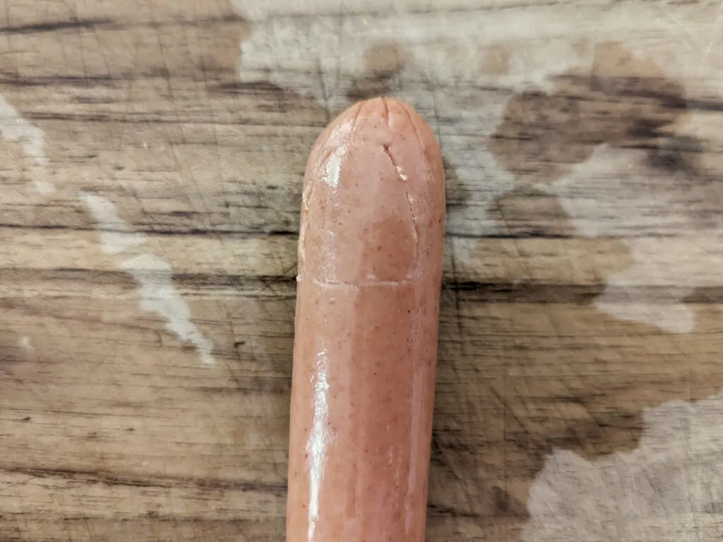 A fingernail traced out on a hotdog.