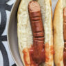 Halloween Hotdog Fingers in between hotdog buns with ketchup.