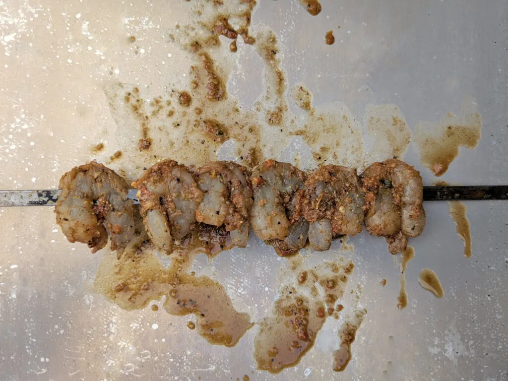 Shrimp lined onto a skewer.