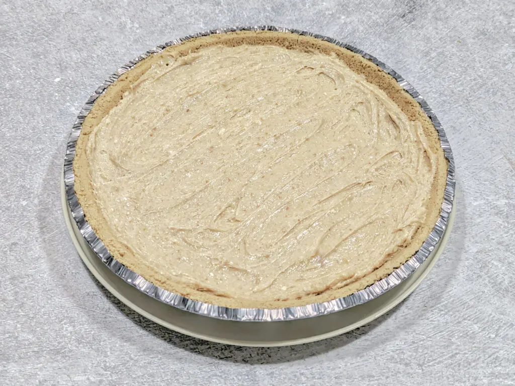 The peanut butter mixture poured into a pre-made crust.
