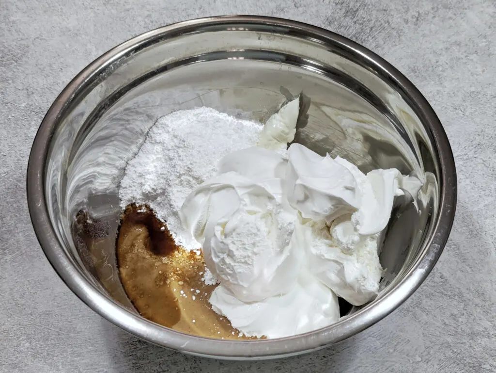 The ingredients for the Silky Peanut Butter Pie Recipe in a mixing bowl.