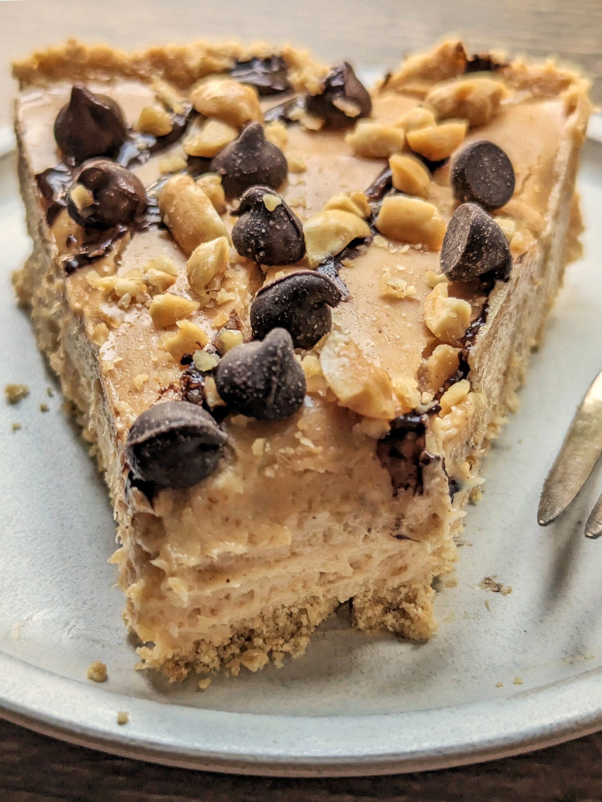 A slice of our Silky Peanut Butter Pie with toppings. 