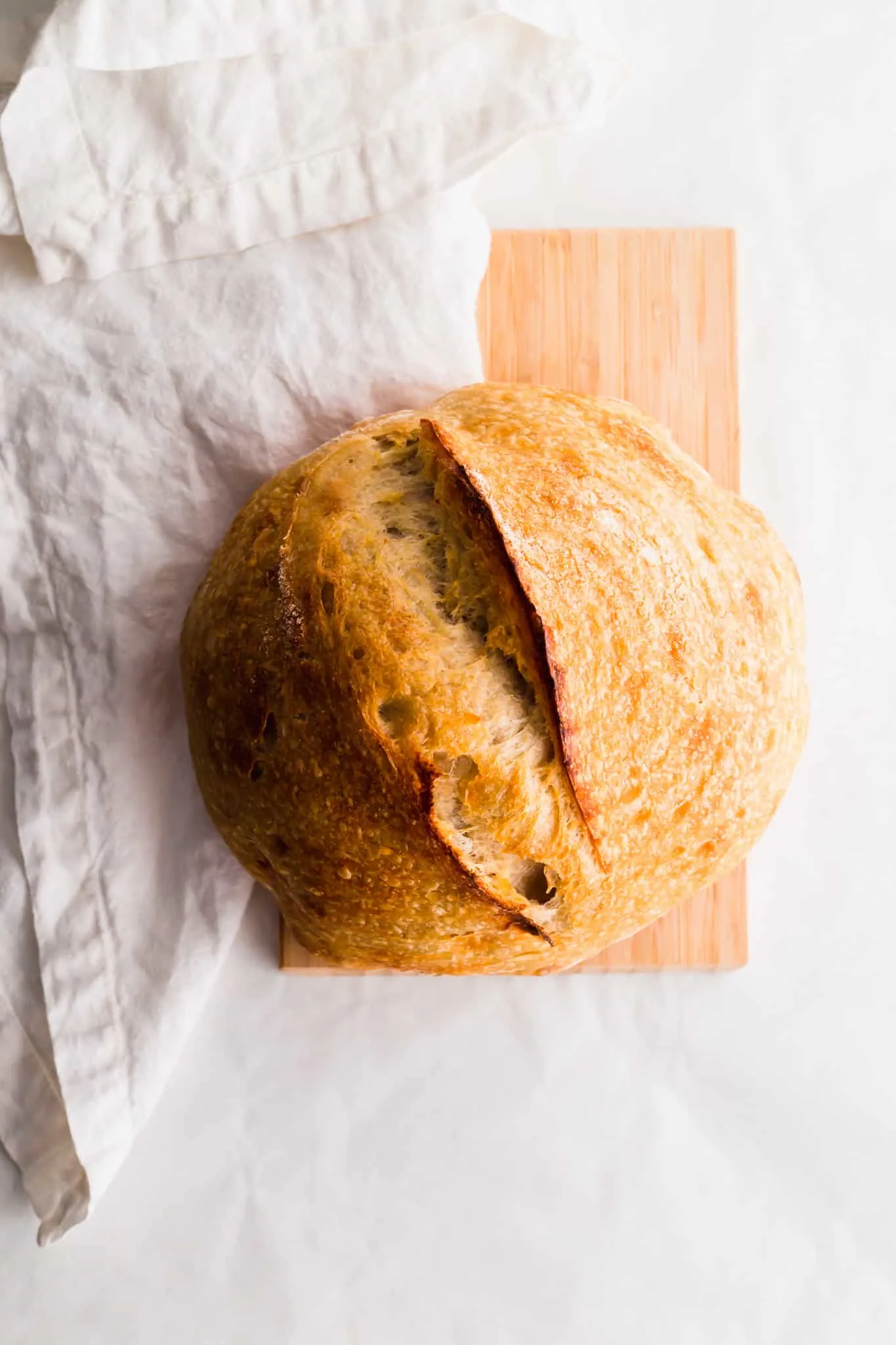 A loaf of sourdough bread on a cutting board. 