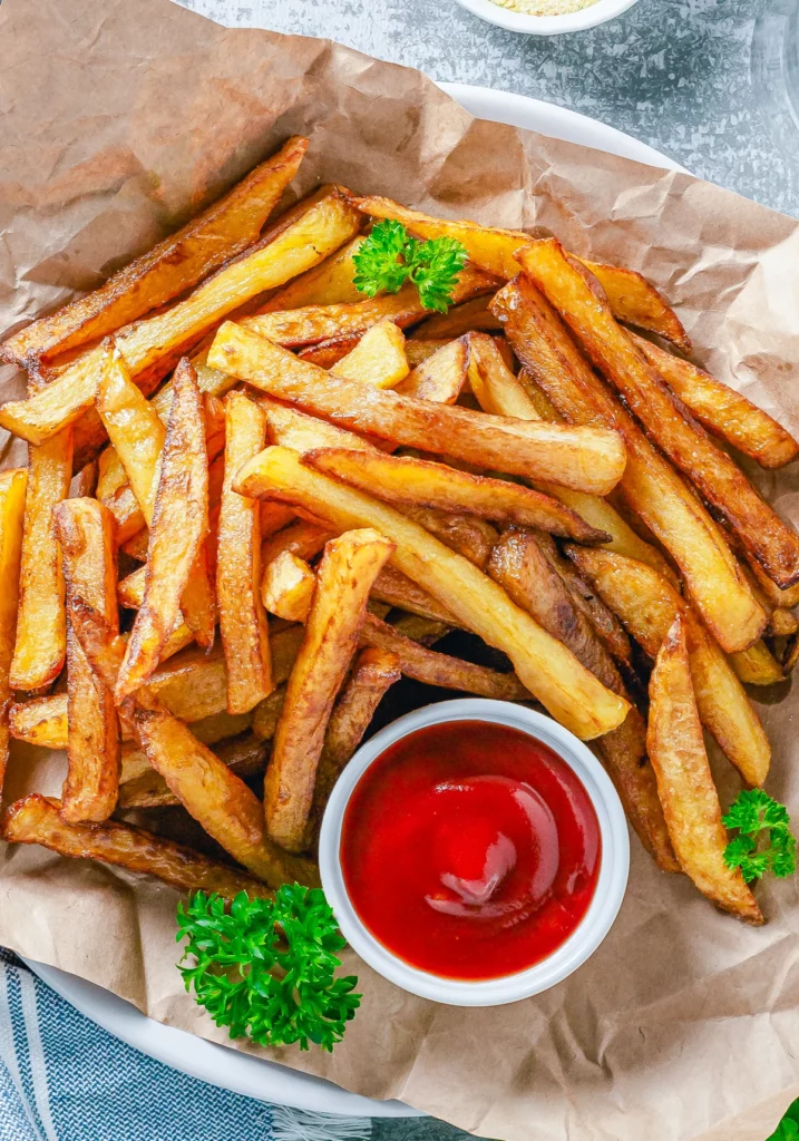 French fries on a plate with ketchup. 