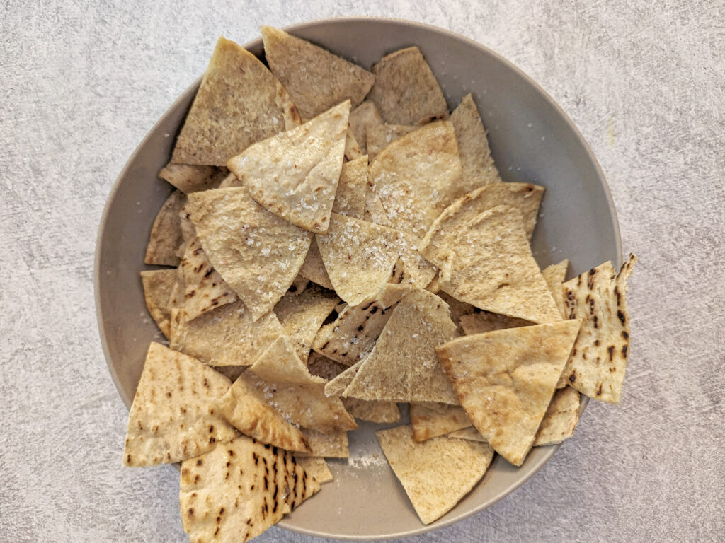 Pita chips sprinkled with kosher salt.