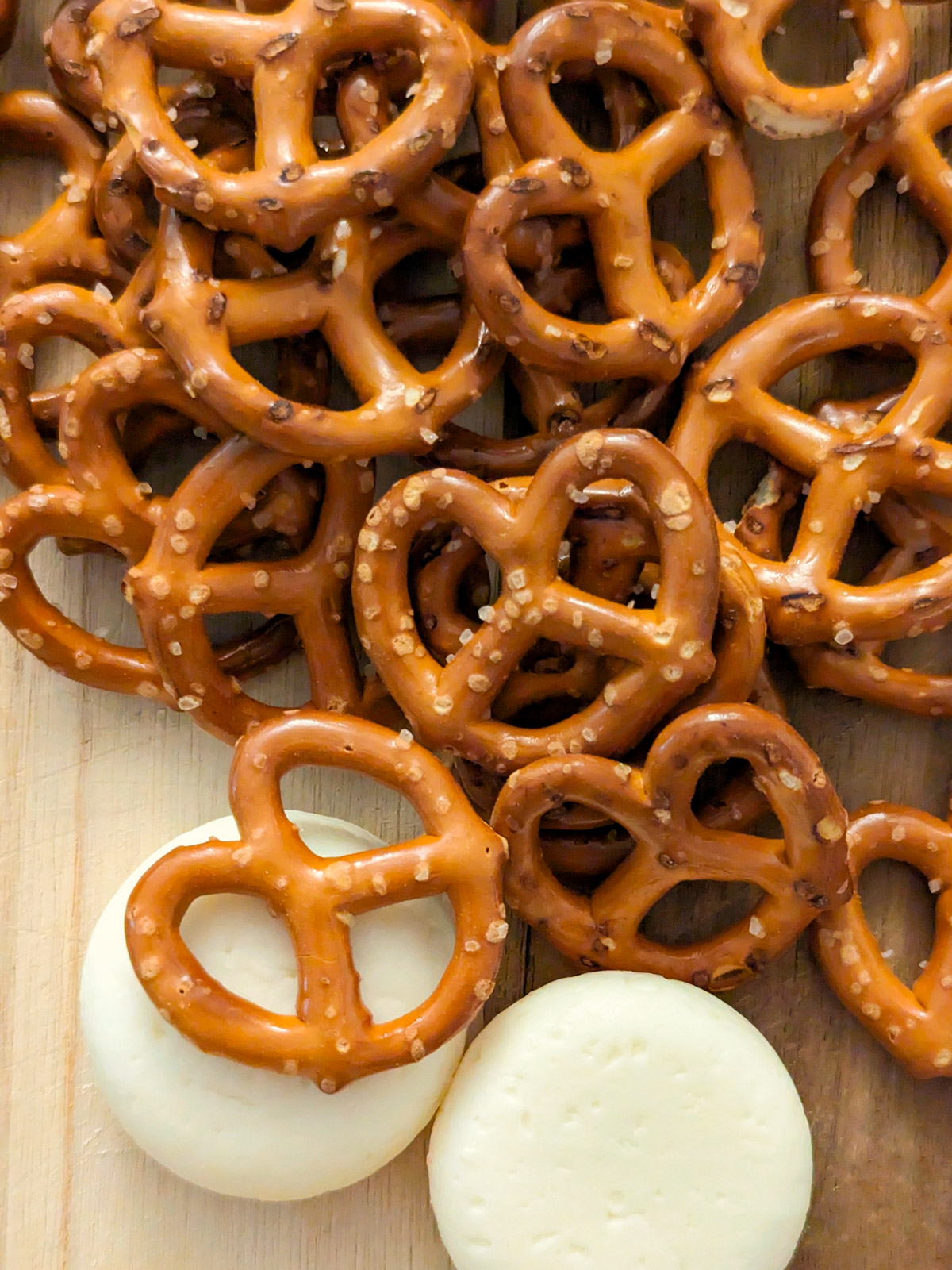 Pretzels on a board with cheese. 