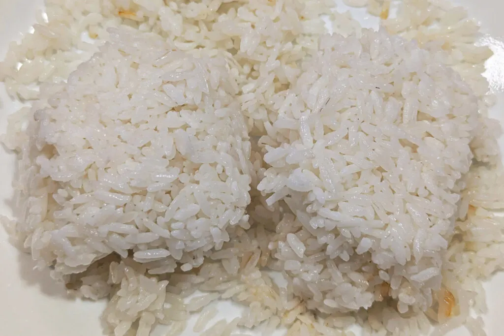 Leftover white rice on a plate.