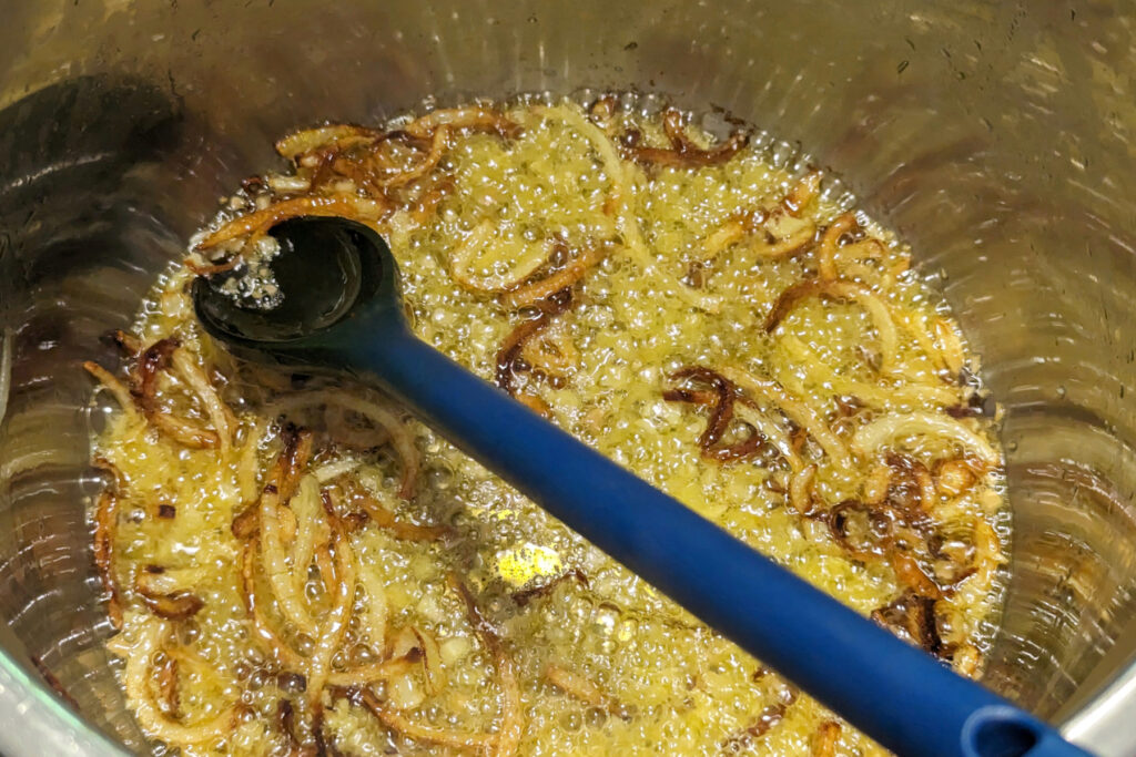 Onions caramelizing in a pot.
