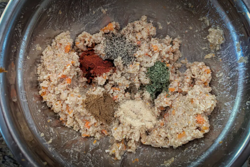Spices added to the quinoa mixture in a bowl.