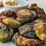 Air Fryer Smashed Brussel Sprouts on a plate with mustard dip.