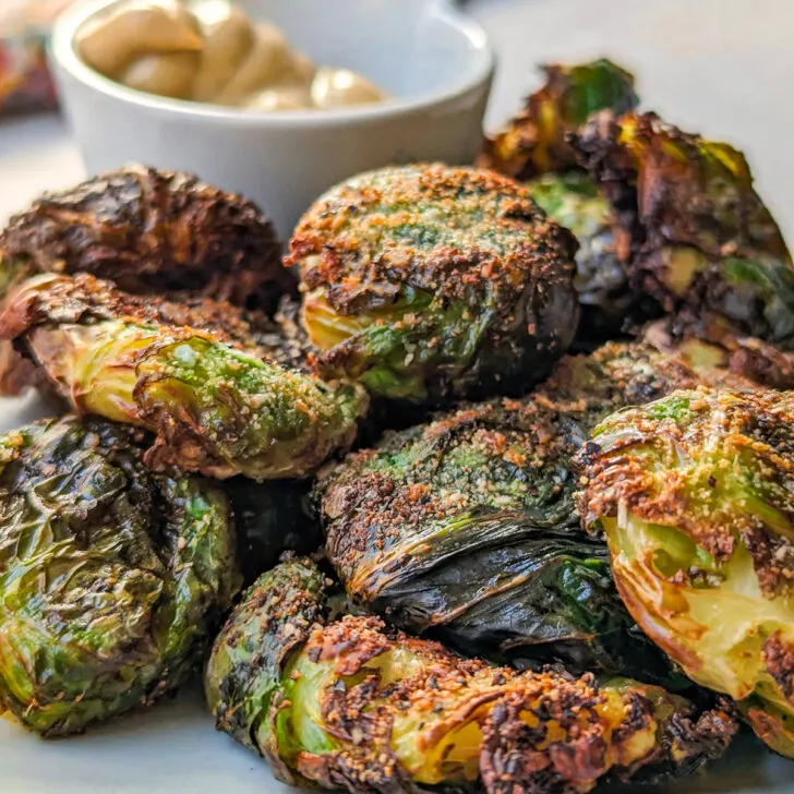 Air Fryer Smashed Brussel Sprouts on a plate with mustard dip.